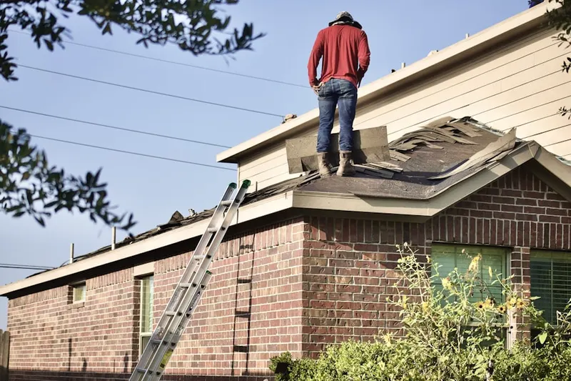 Professional roofer working on a residential roof in Moodus